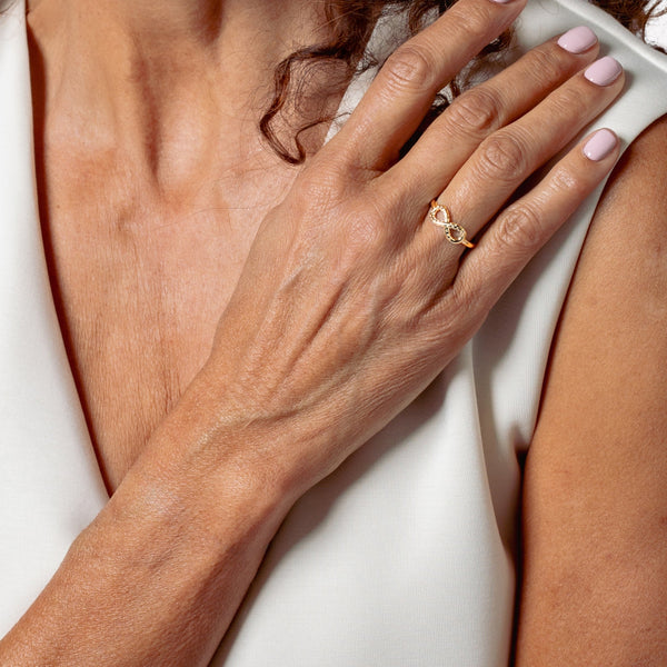 18k gold vermeil Infinite Hope Statement Ring showcases a pavé zirconia ichthys nestled within the infinity symbol on a woman