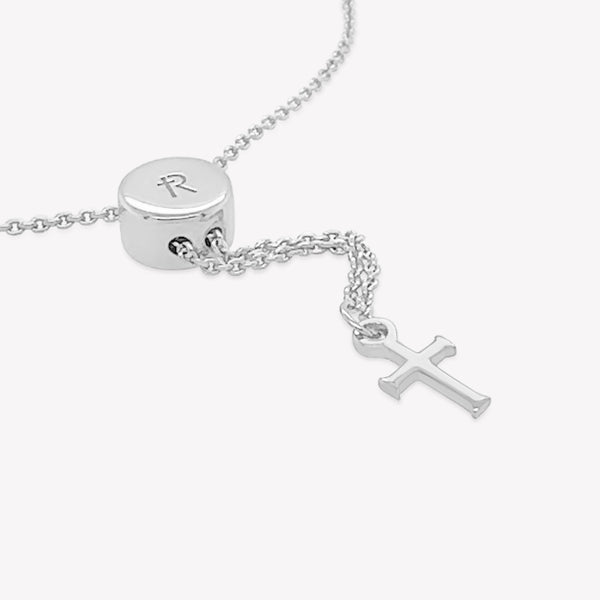 Close up of the intricately designed sterling silver Olive Branch Bracelet with cross tag from the Rooted Collection by Rizen Jewelry.